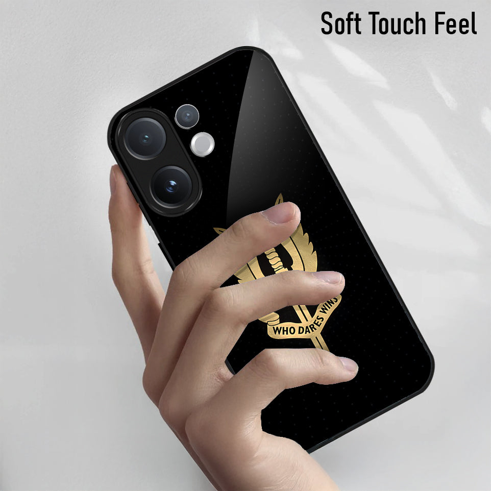 Black phone case with gold emblem held by a hand on a light gray background