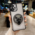 Phone case with butterfly design holder held by a hand in an indoor setting